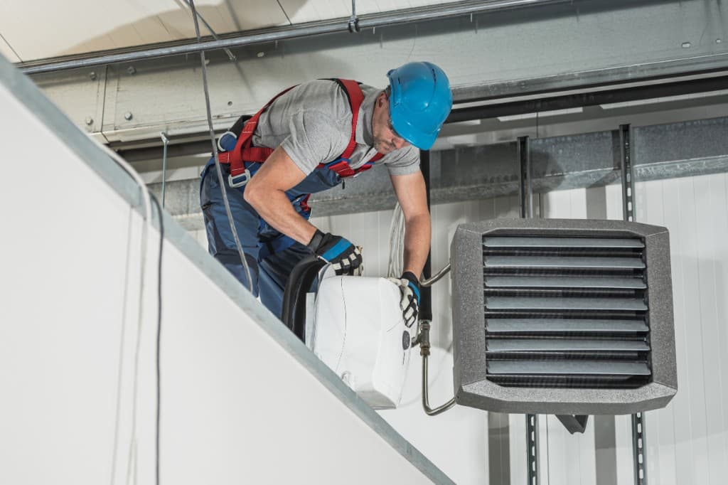 HVAC technician servicing commercial equipment, representing home service field operations.